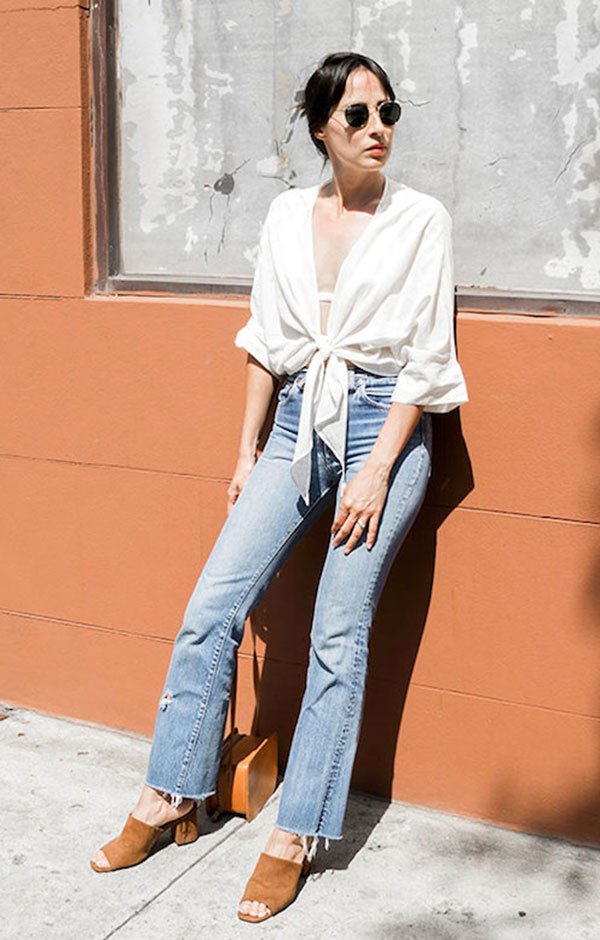 Street style look com camisa branca, calça jeans e mule marrom.
