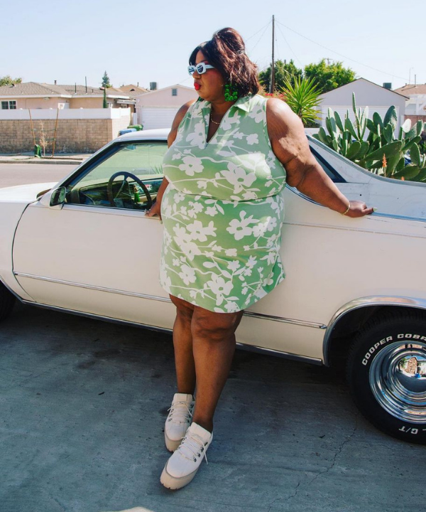 Kellie Brown - Vestido verde florido e tênis - looks novos - verão - encostada em um carro - https://stealthelook.com.br