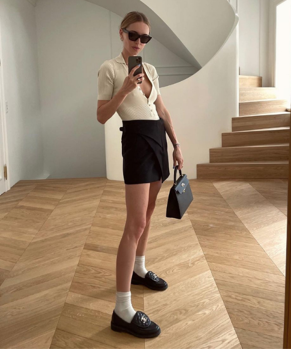 Pernille Teisbaek - blusa de tricot com mini saia preta e loafer - tendência para o verão 2022 - Verão 2022 - foto no espelho - https://stealthelook.com.br