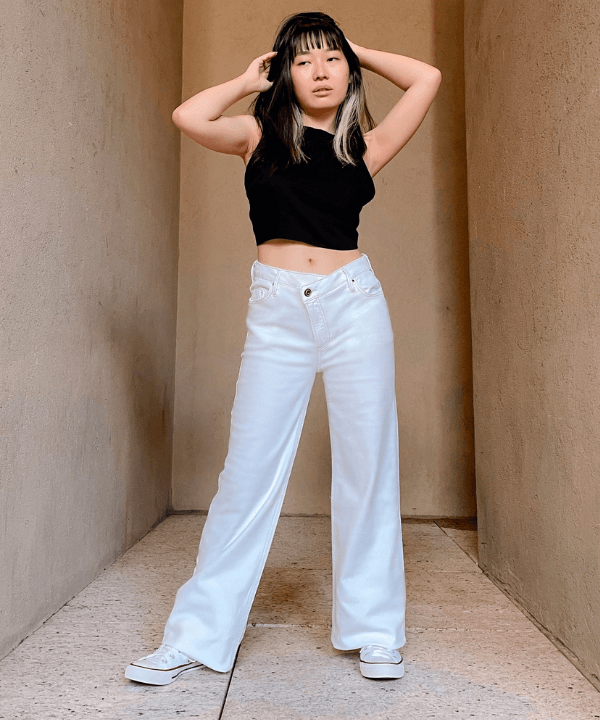Milena Otta - calça jeans branca e cropped preto - looks com calça branca - verão - em pé na rua - https://stealthelook.com.br