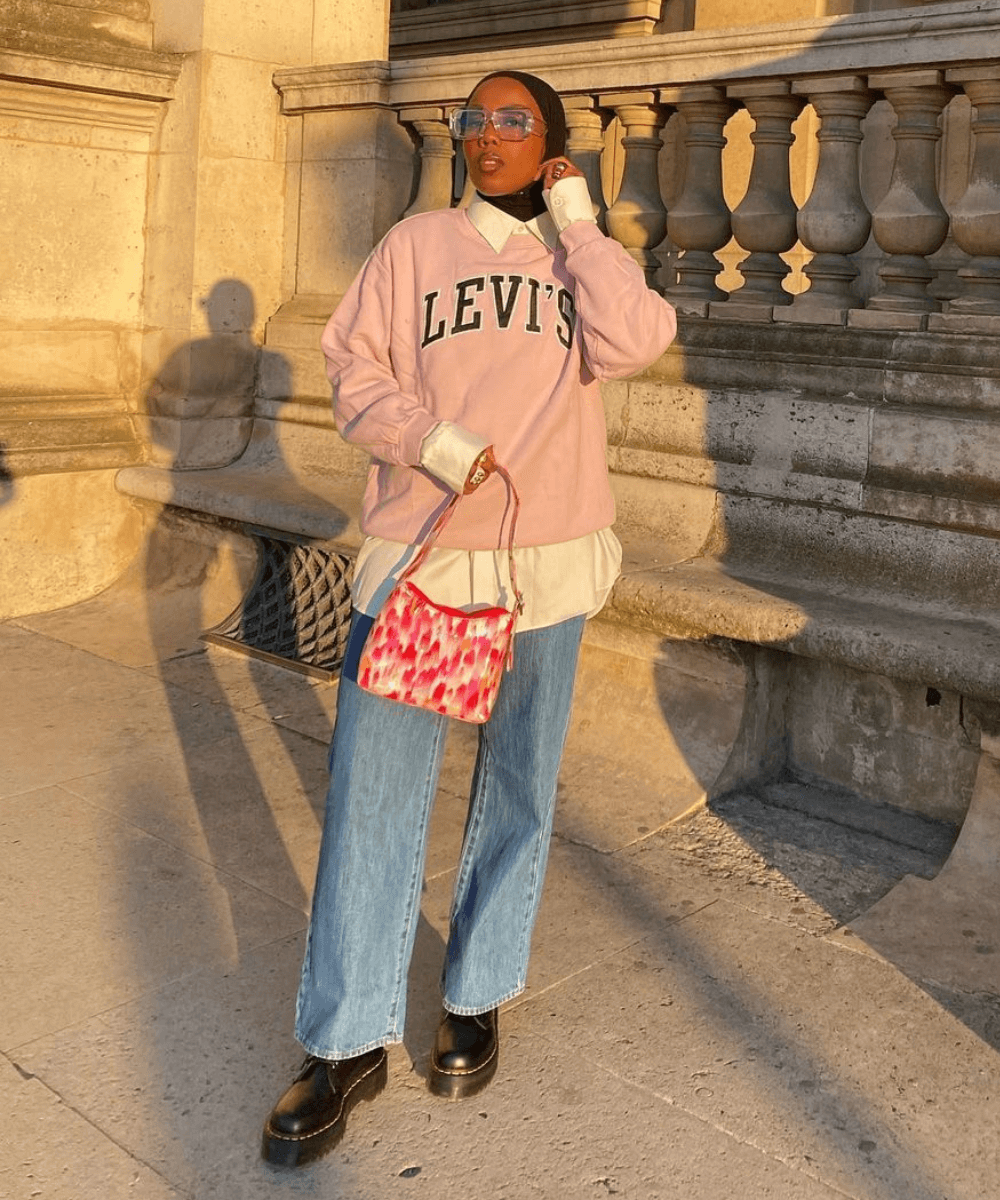 Safya | @blackmaroccan - calça jeans, blusa branca e sobreposição de moletom rosa - looks novos - Inverno  - em pé na rua - https://stealthelook.com.br