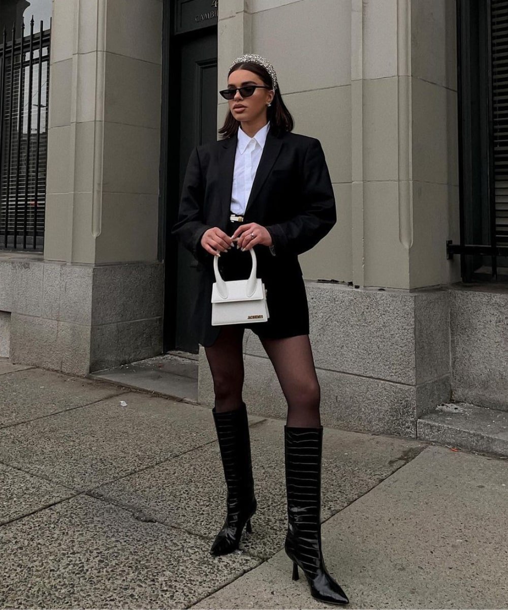 @vitaliia - minissaia preta, meia-calça, botas de cano longo e blazer - looks com saia - Inverno  - em pé na rua usando óculos de sol - https://stealthelook.com.br