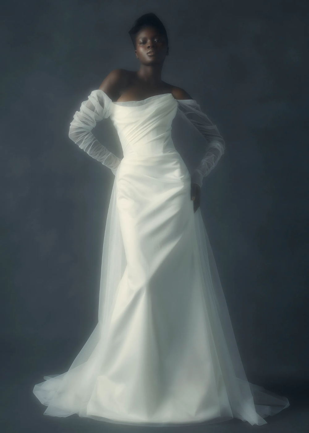Rhea Dress by Vivienne Westwood - vestido de noiva branco longo - vestidos de noiva - outono - mulher negra usando vestido de noiva em pé com fundo azul marinho - https://stealthelook.com.br