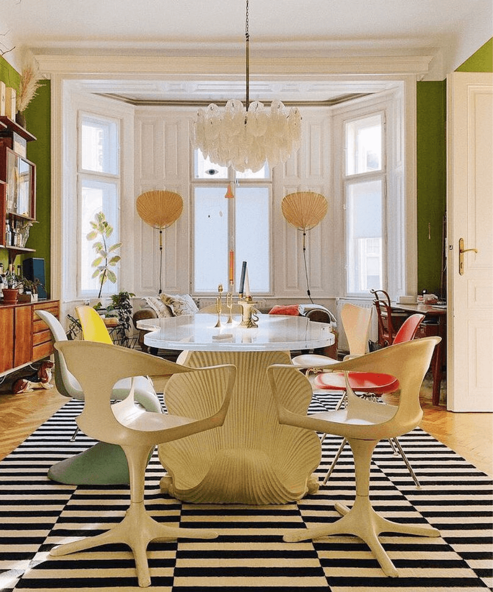 @laurakarasinski -     - itens para casa - outono - foto de um cômodo com uma mesa, cadeiras, um tapete retangular grande em preto e branco e paredes verdes - https://stealthelook.com.br