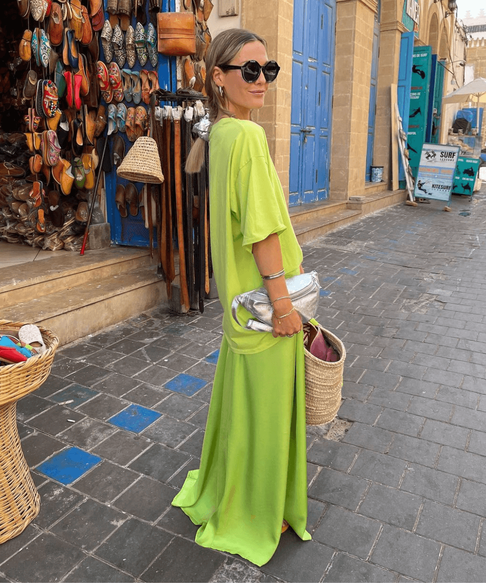 @tinvcb - saia longa verde, t-shirt verde, óculos escuros e bolsa - look da virada - verão -  mulher loira de coque em pé na rua usando óculos de sol - https://stealthelook.com.br