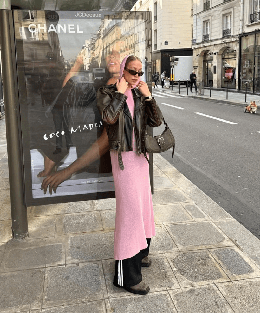 Marleen Elisabeth - calça adidas azul, vestido longo rosa, jaqueta de couro marrom e óculos escuros - cool girls - inverno - mulher em pé na rua usando óculos de sol - https://stealthelook.com.br