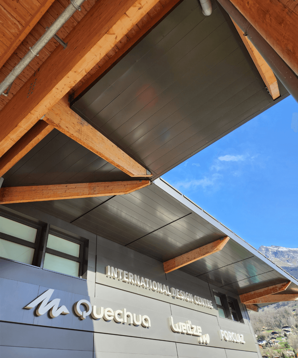 Mountain Store - Centro de Inovação e Design da Decathlon - N/A - neve - inverno - a foto mostra a faixada de uma loja em cinza, com escritos e telhado de madeira - https://stealthelook.com.br