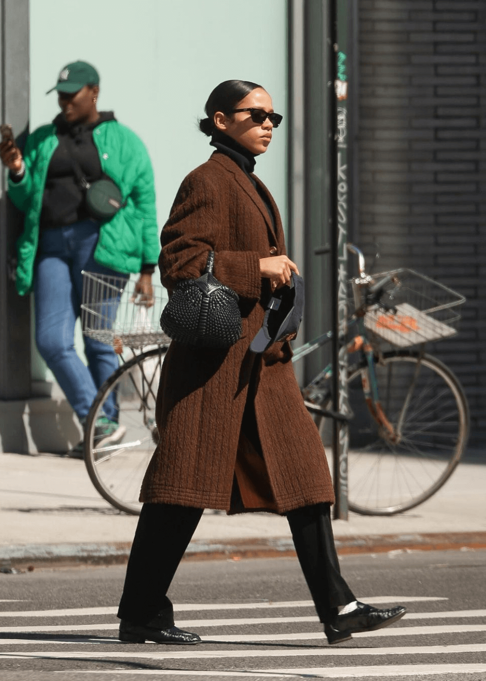 Taylor Russell - calça jeans, tricot marrom, sapato preto e óculos - Taylor Russell - outono - mulher de óculos andando na rua - https://stealthelook.com.br
