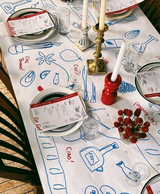 mesa de reveillon coberta com papel e desenhos temáticos