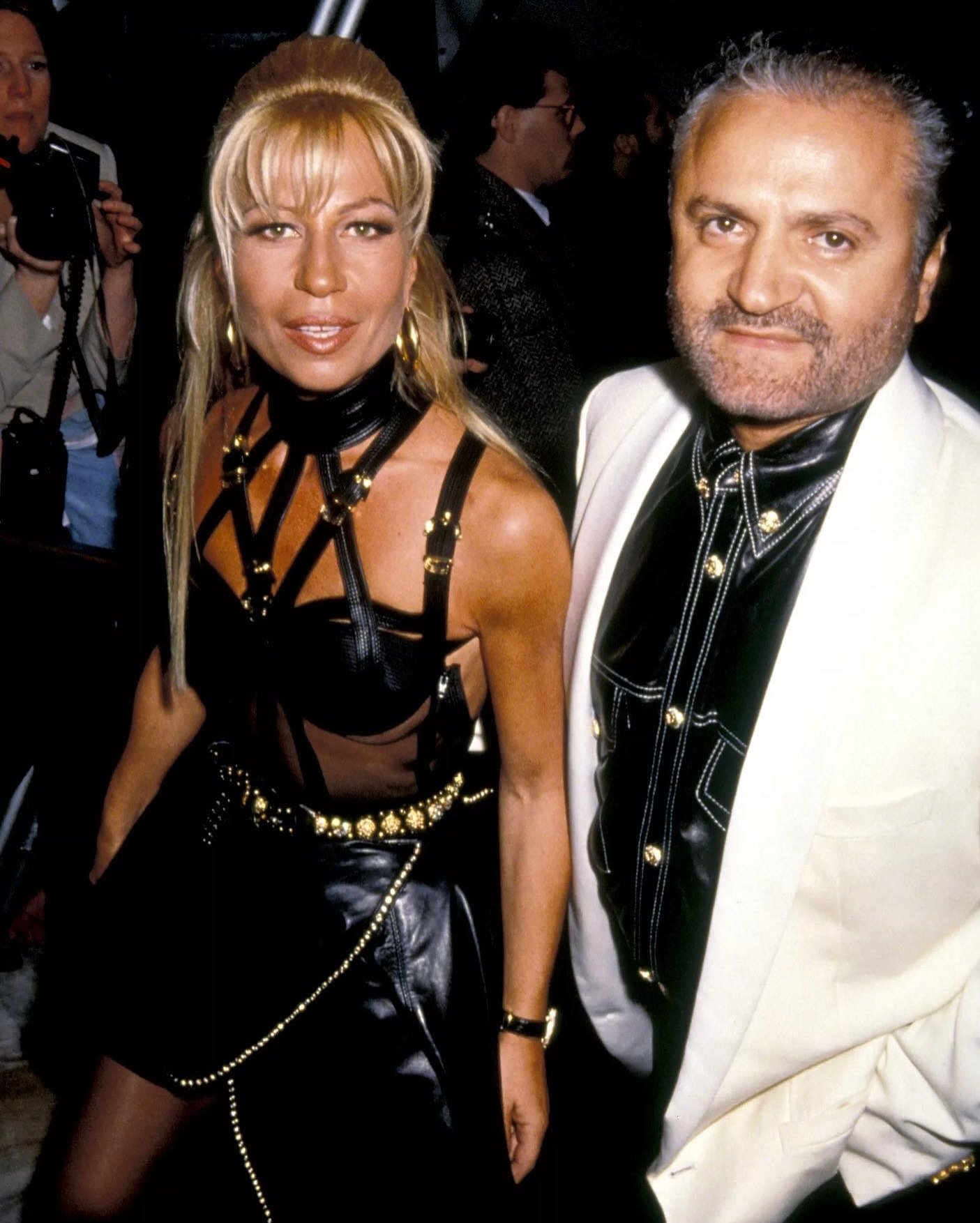 Eles vestem roupas elegantes e olham para frente. Simbolizando um dos momentos mais icônicos de Donatella na Versace.