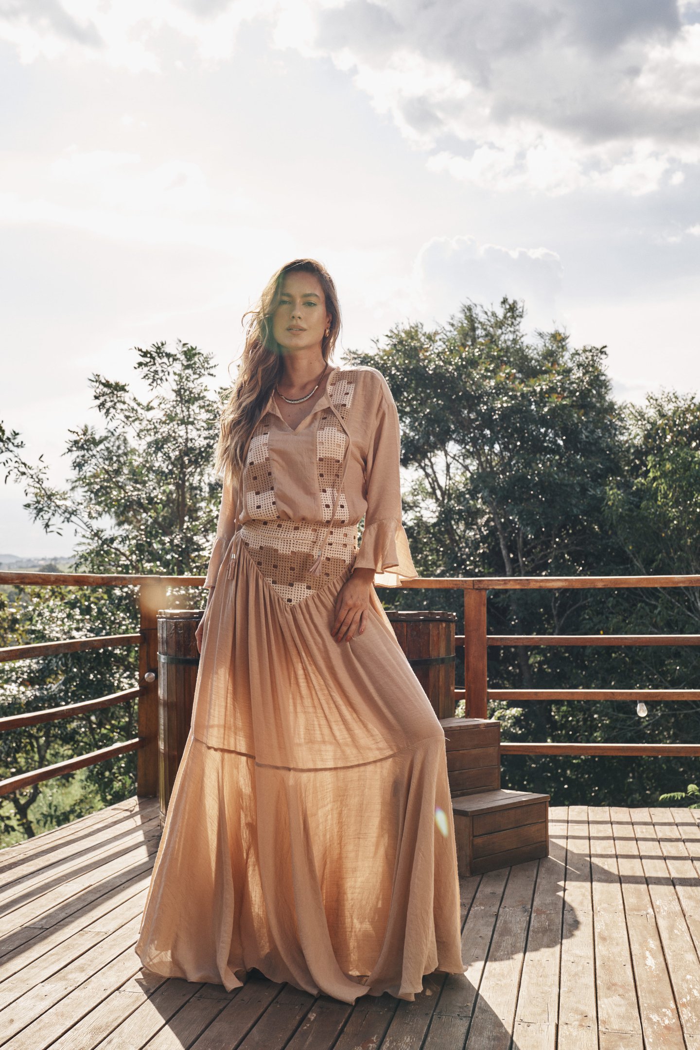 mulher usando estilo country com vestido fluido e botas