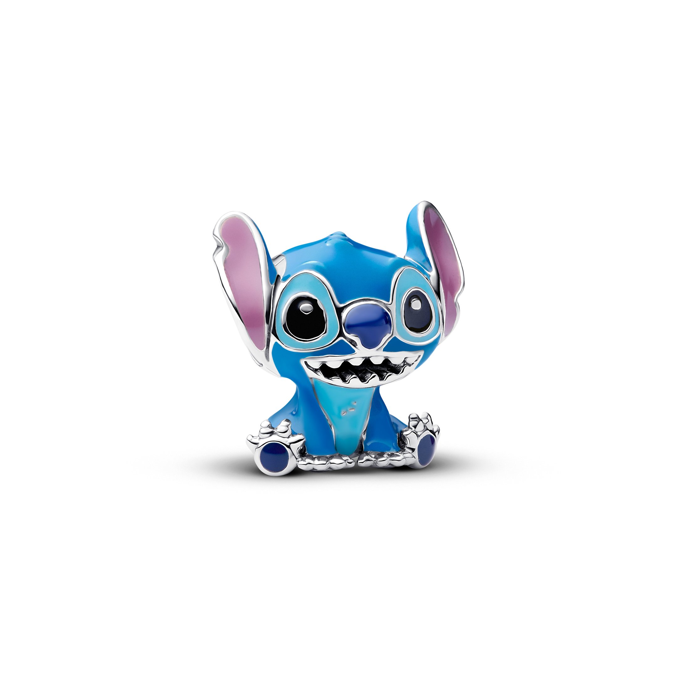Brinquedo de metal azul representando Stitch, do filme Lilo & Stitch, com grande sorriso e orelhas longas.
