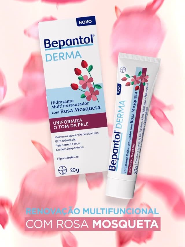 Caixa e tubo de Bepantol Derma com rosa mosqueta em fundo com pétalas rosas.