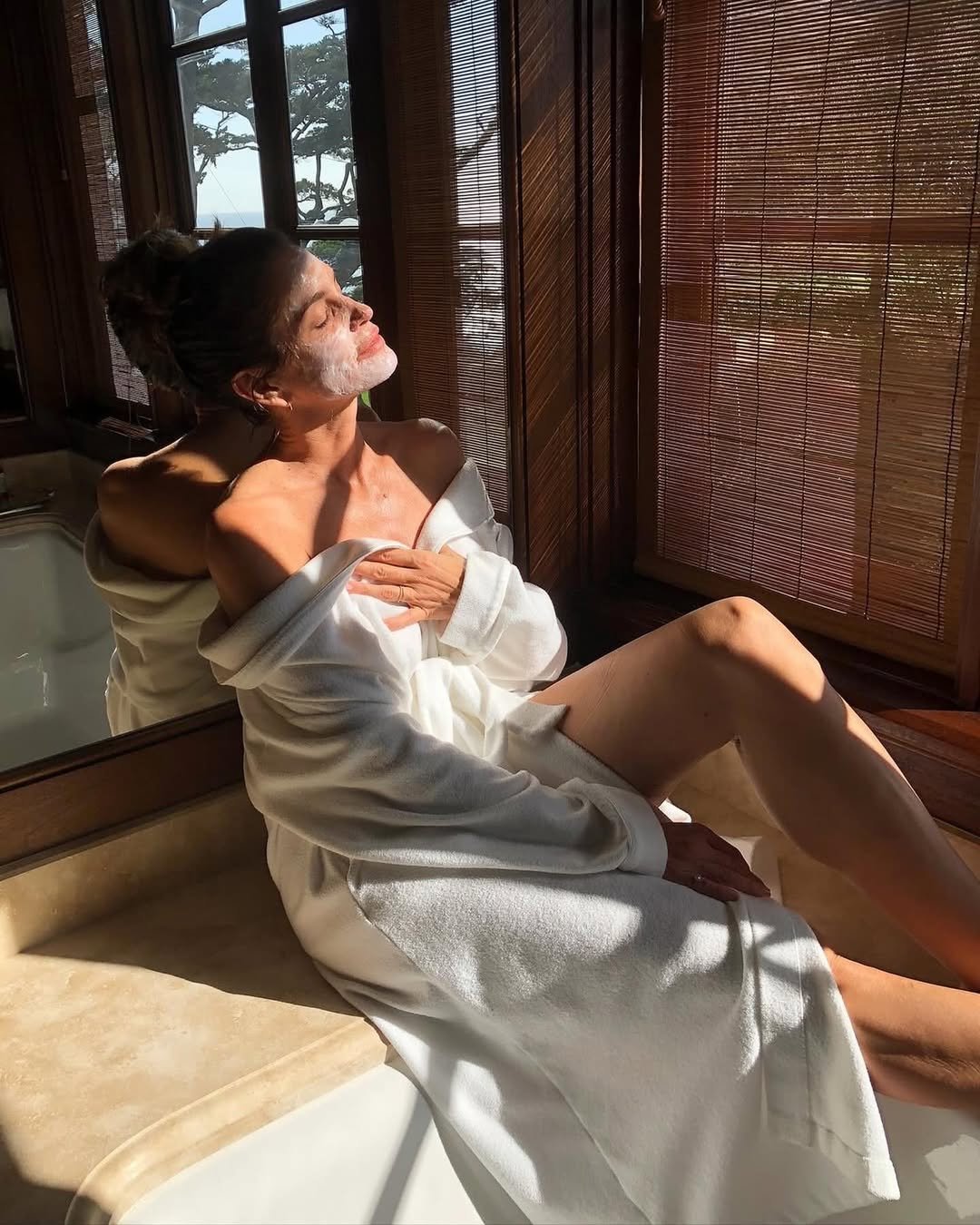 atriz posando com roupão pós banho com pele hidratada