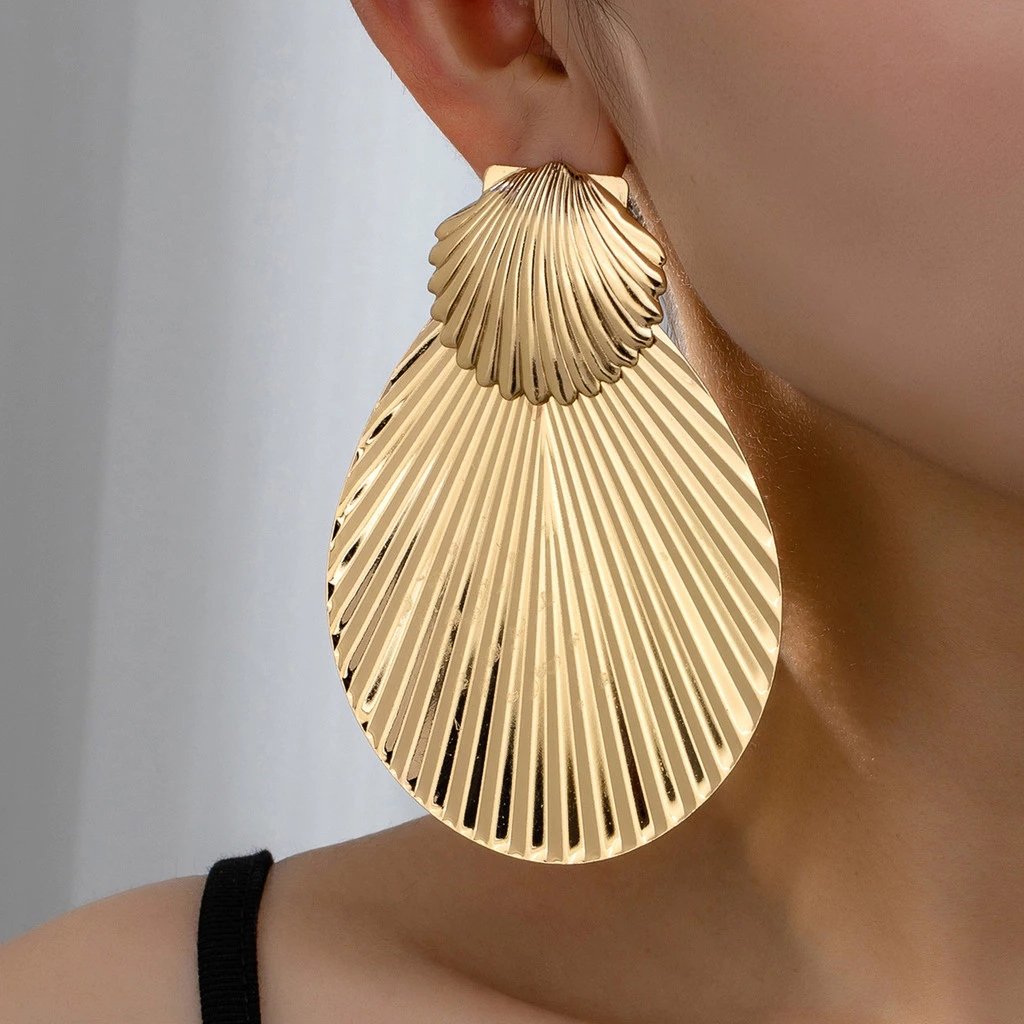 Um par de conchas douradas retrô exageradas férias estilo praia brincos ele