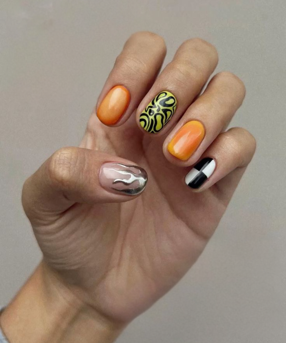 Unhas decoradas com diferentes designs, incluindo padrões abstratos, cores vibrantes e temas metálicos.