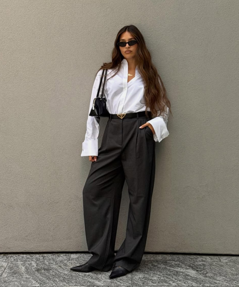 Look moderno com bolsa de ombro estilosa, camisa branca oversized e calças de alfaiataria. Estilo minimalista e elegante.