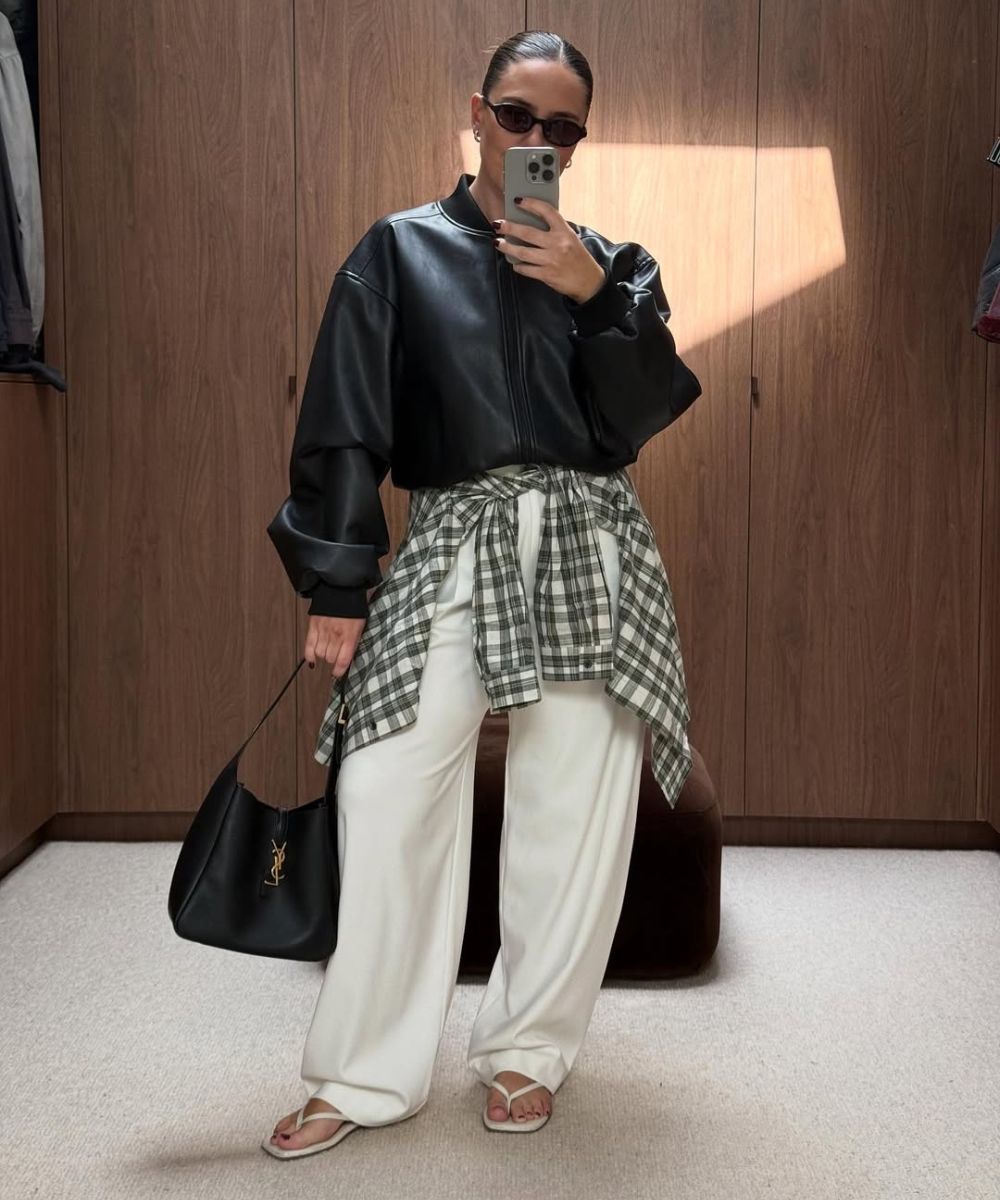 Look moderno com camisa amarrada na cintura, blusa de couro, calça ampla e acessórios elegantes. Estilo casual e contemporâneo.