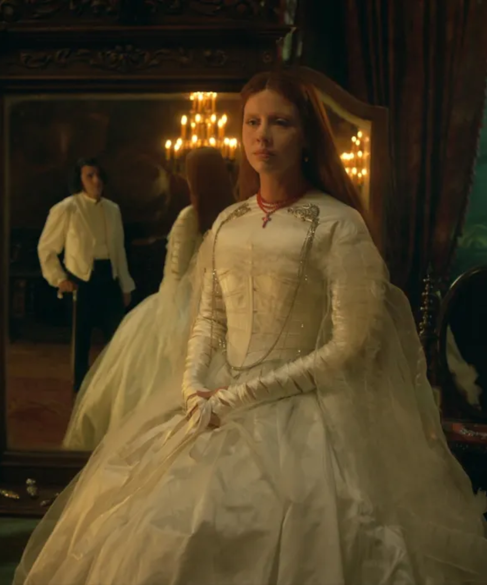 Figurino de Frankenstein com vestido branco volumoso em tecido acetinado, mangas longas ajustadas e detalhes prateados,