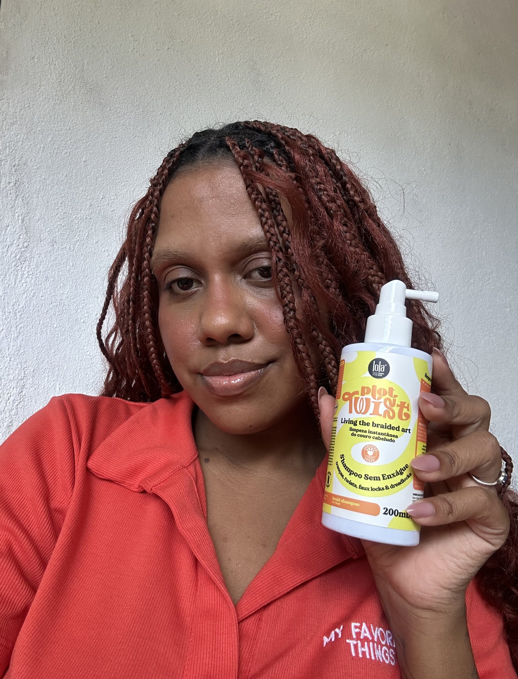 Mulher segurando shampoo para trança sem enxágue da Lola Cosmetics