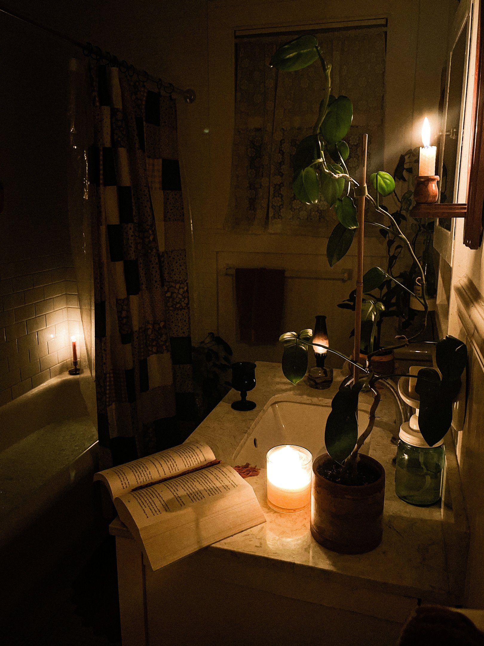 Banho premium com iluminação suave de velas, plantas naturais e decoração aconchegante em tons quentes que convidam ao