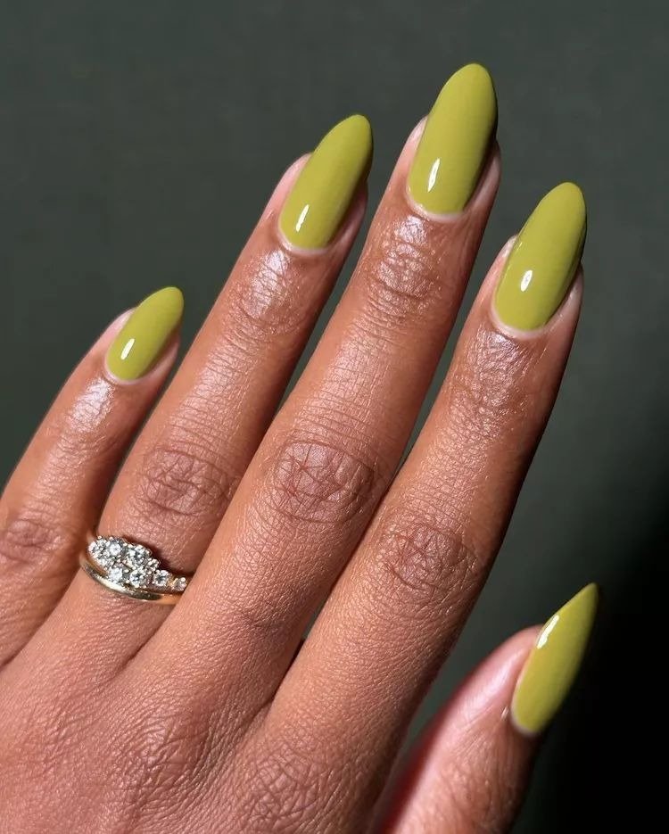 Unhas para Ano Novo em formato amêndoa com esmalte verde oliva brilhante realçam elegância e sofisticação discreta.