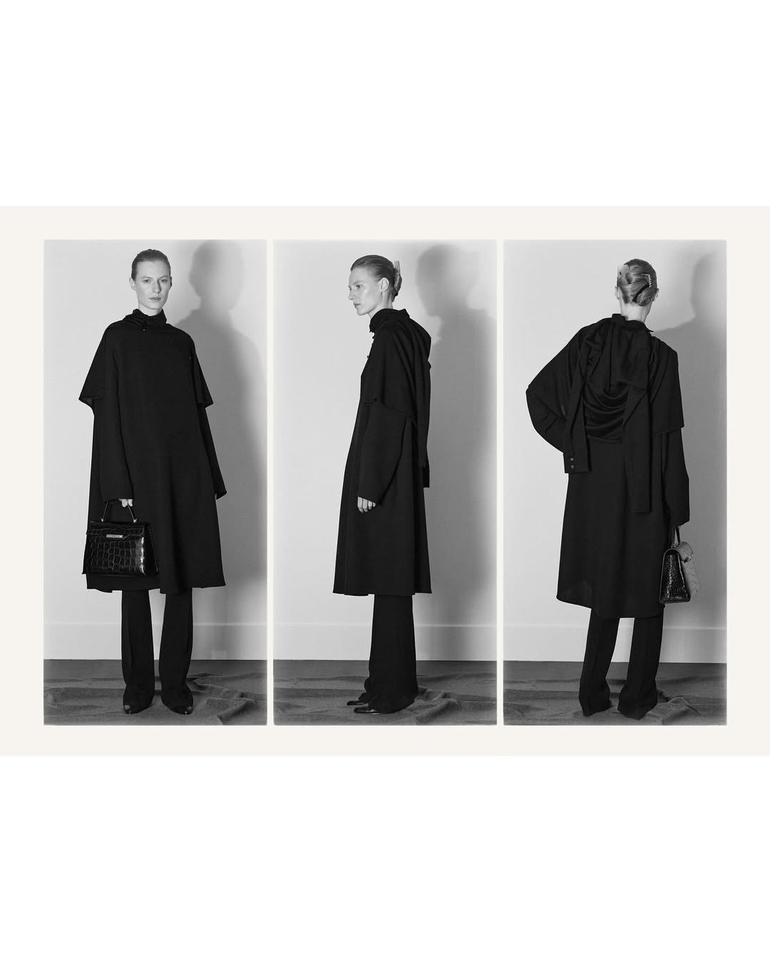 Modelo posa em três ângulos com look monocromático preto, casaco oversized de tecido estruturado e bolsa de couro