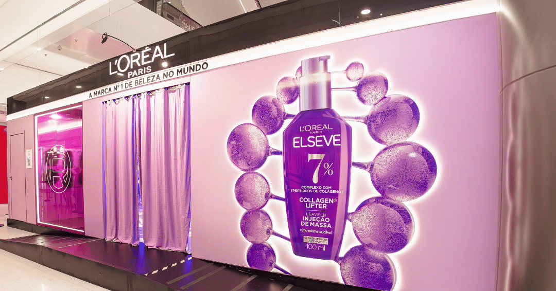 Futuro da beleza em estande lilás neon com frascão Elseve e clima tecnológico.