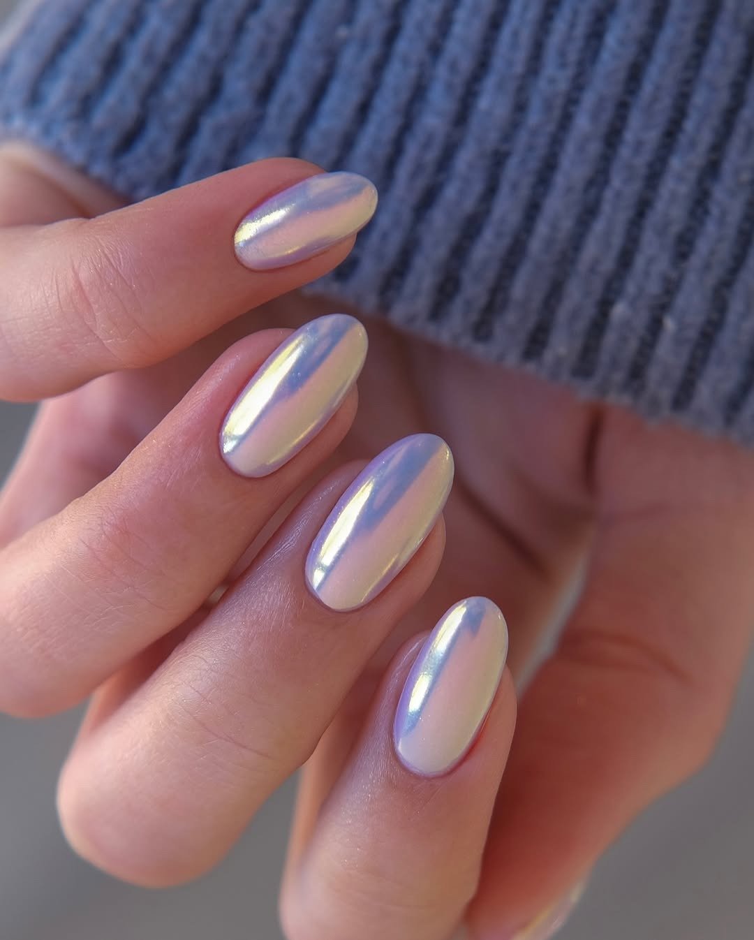 Unhas para madrinha de casamento em formato amendoado com esmalte perolado branco e brilho lilás, clima elegante e delicado